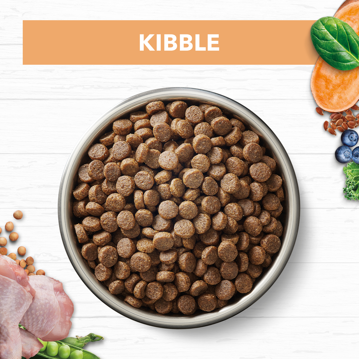 Ivory Coat Grain Free Chicken kitten kibble in a bowl with raw ingredients