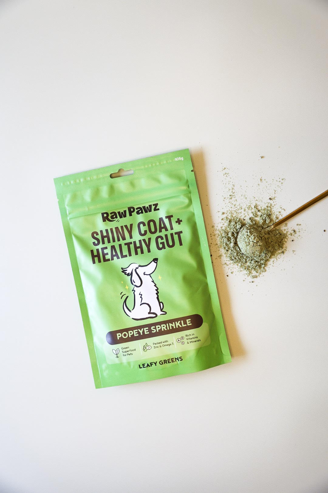 Raw Pawz essential greens meal topper sprinkled over a dog bowl