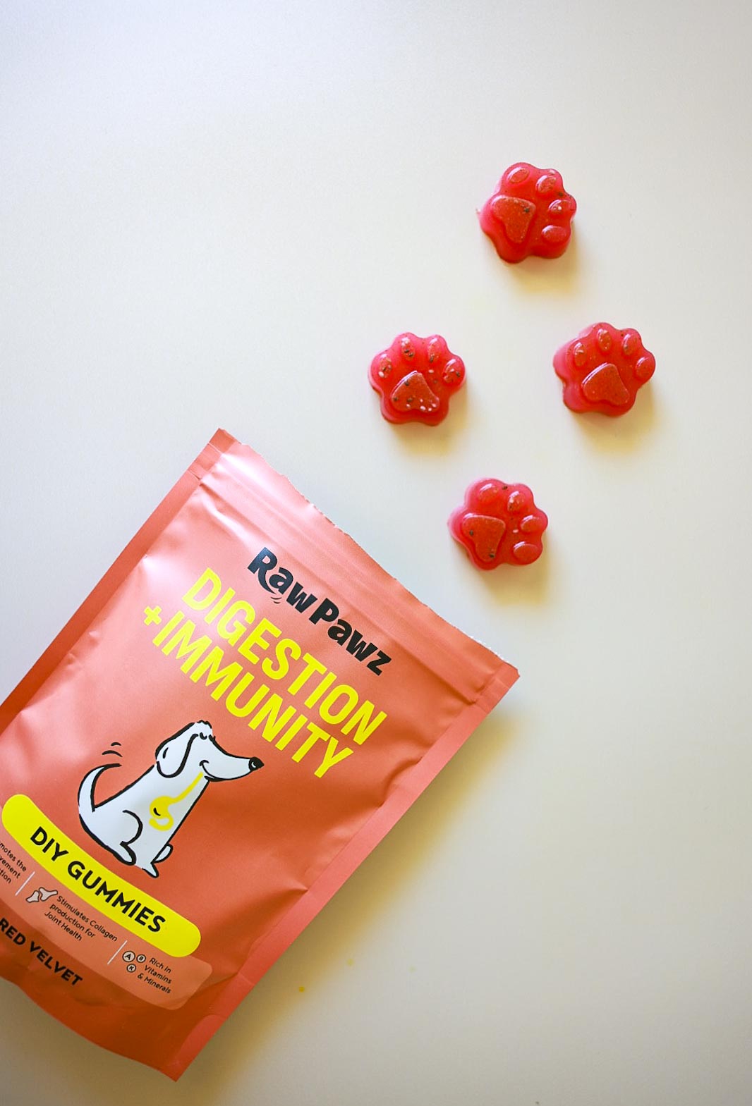 Set Raw Pawz beetroot and collagen gummies on a plate