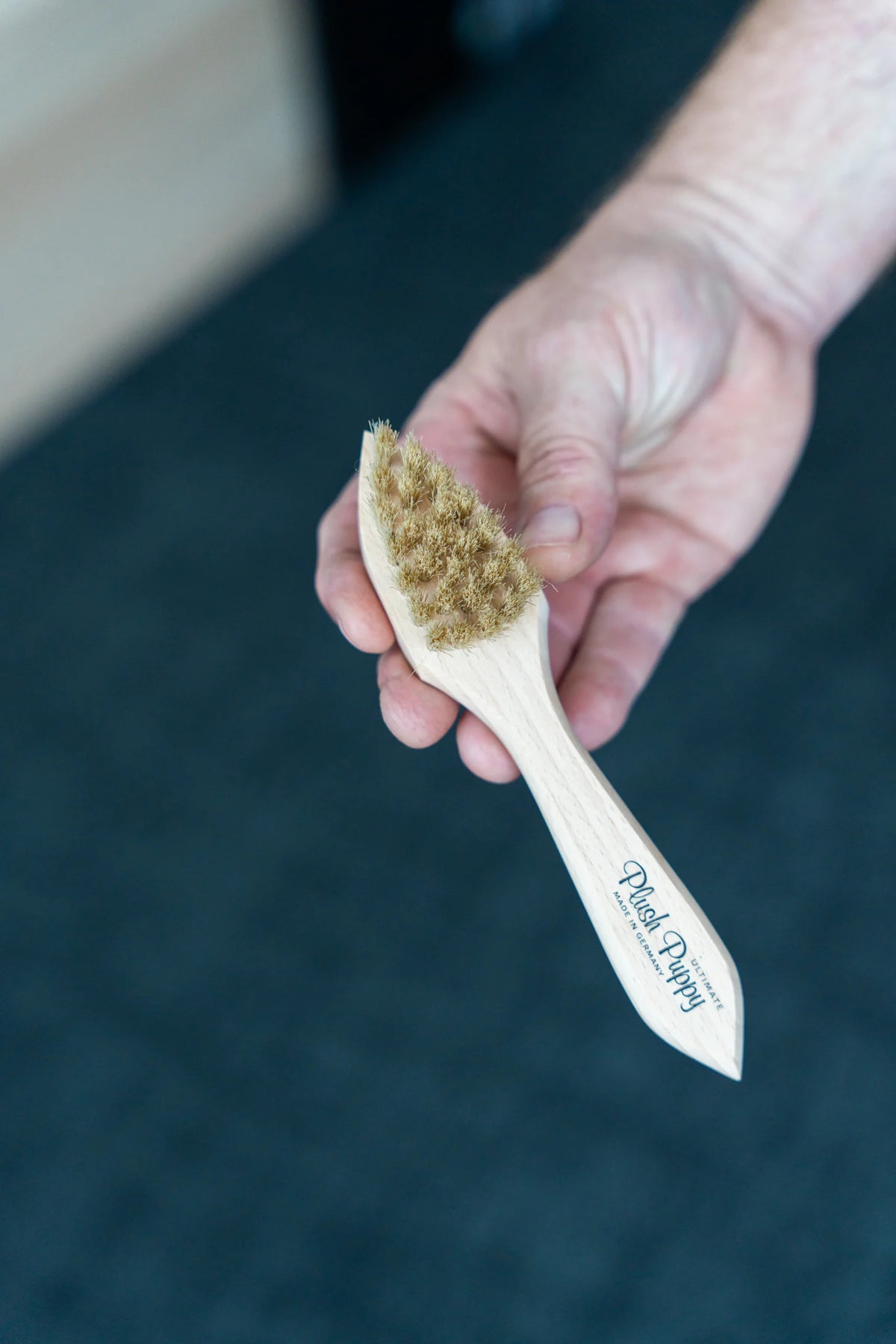 Plush Puppy Ultimate Powder Application Brush – held in hand to show size