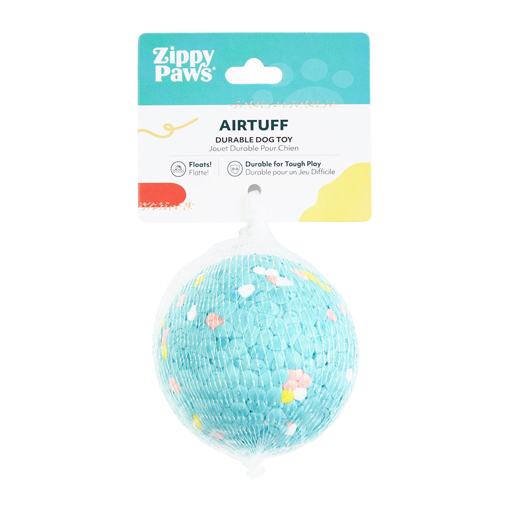 Dog carrying the Zippy Paws AirTuff Ball outdoors