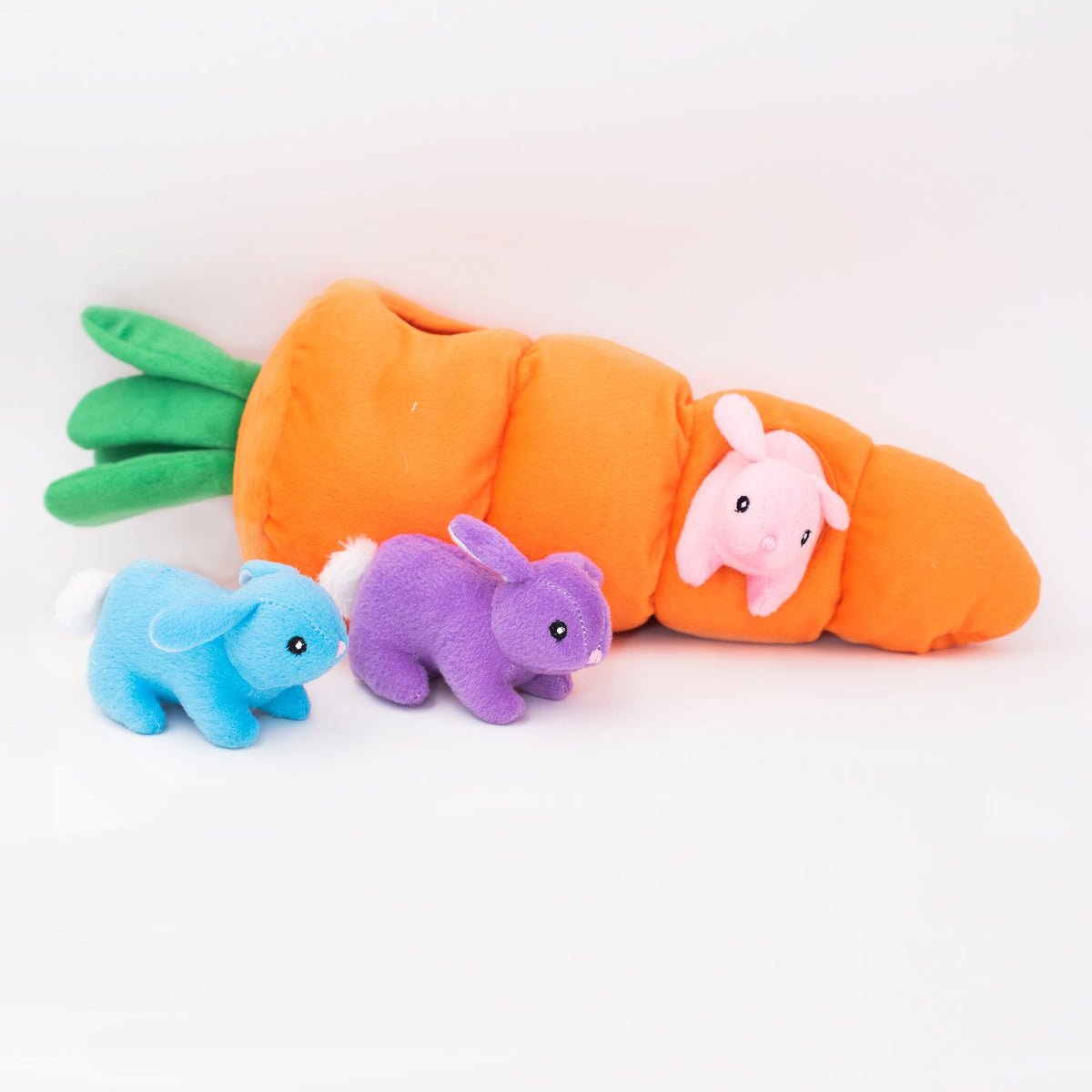 Easter Carrot burrow laid flat beside the three squeaky bunnies