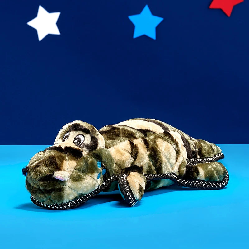 Zippy Paws Grunterz camo gator plush dog toy styled on a navy backdrop with stars