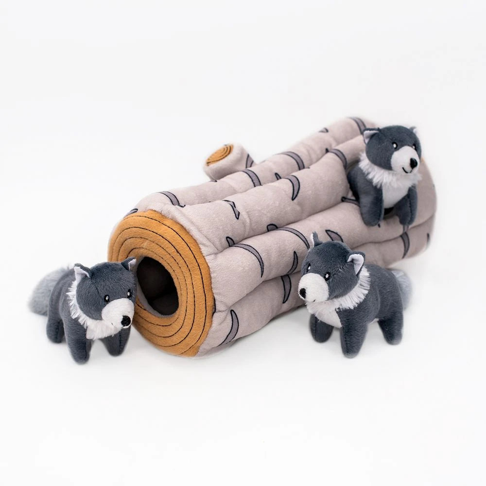 Zippy Paws Burrow arctic wolf log dog toy with its squeaky wolves beside the opening