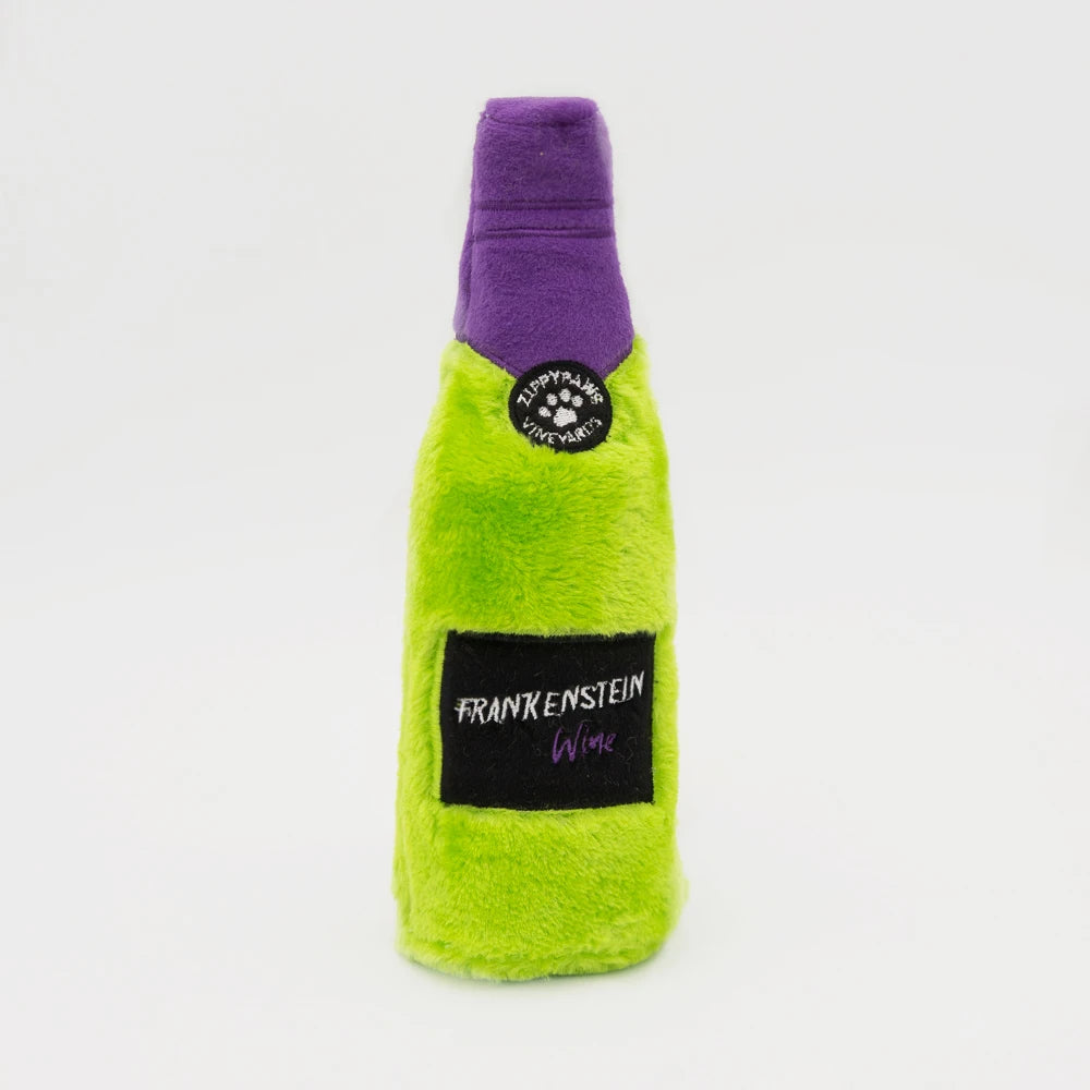 Zippy Paws Happy Hour Crusherz plush dog toy: a green Frankenstein wine bottle, on white