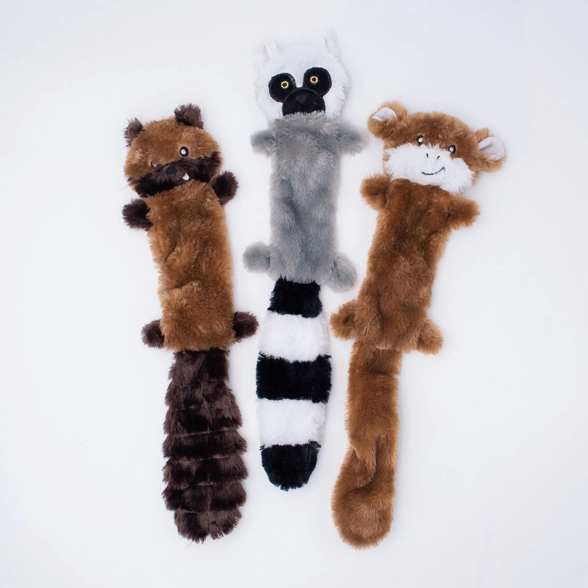 Three Zippy Paws Skinny Peltz stuffing-free plush dog toys: monkey, lemur and chipmunk