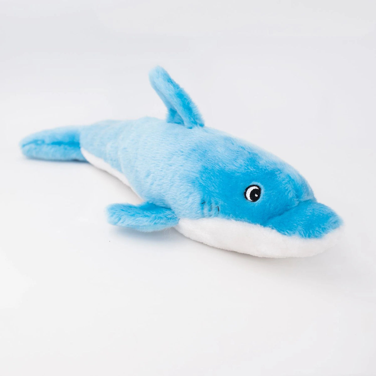 Zippy Paws Jigglerz plush blue dolphin dog toy seen from the other side, on white