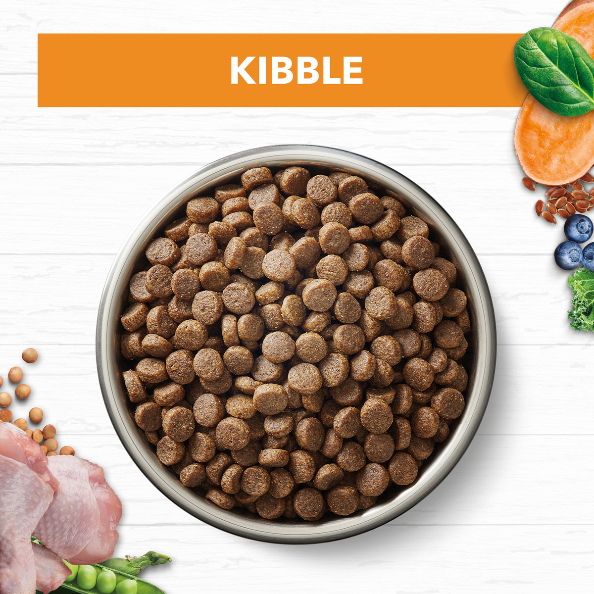 Ivory Coat Grain Free Chicken cat kibble in a bowl with raw ingredients