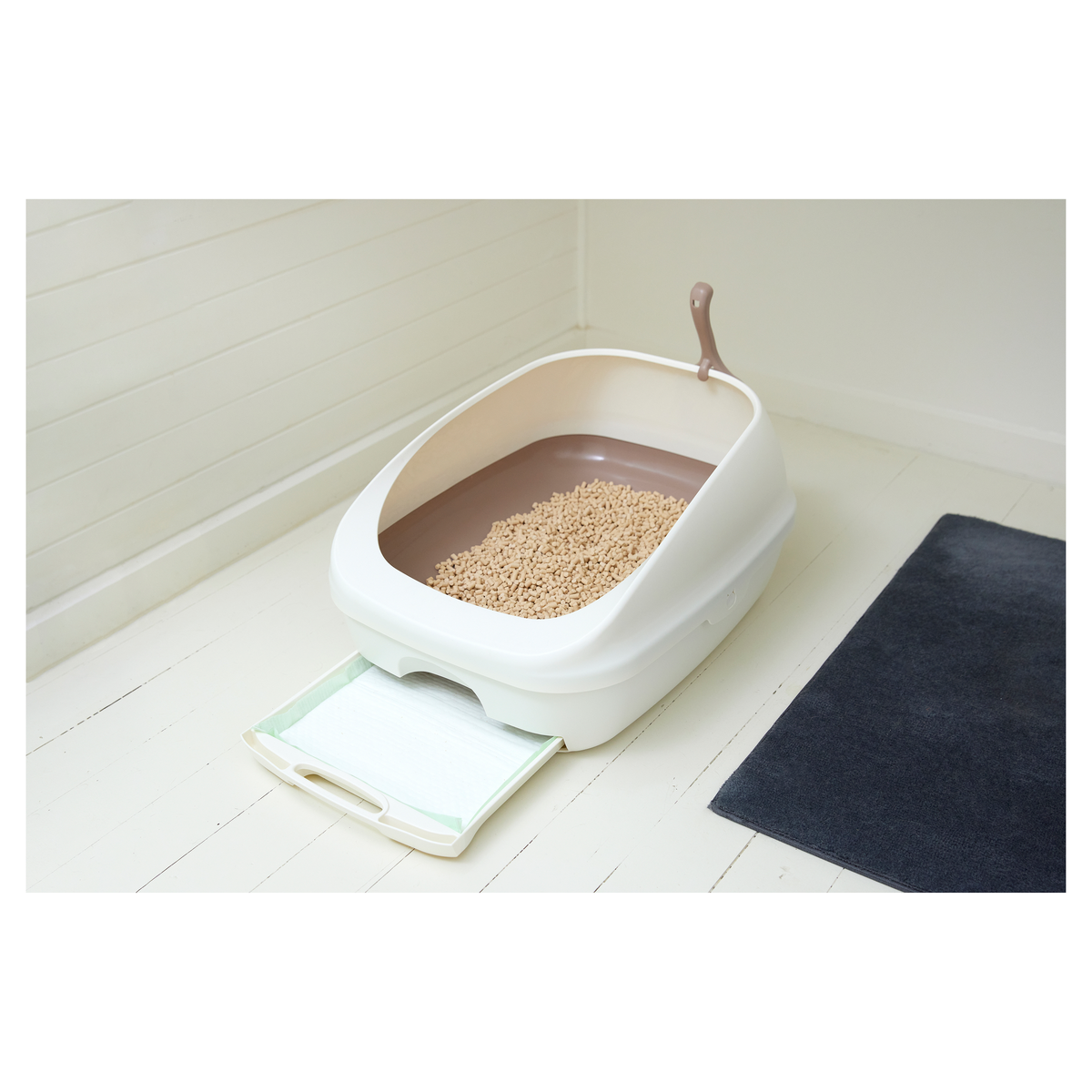 Cream Ezi-LockOdour litter tray on a white floor with the pad drawer sliding out