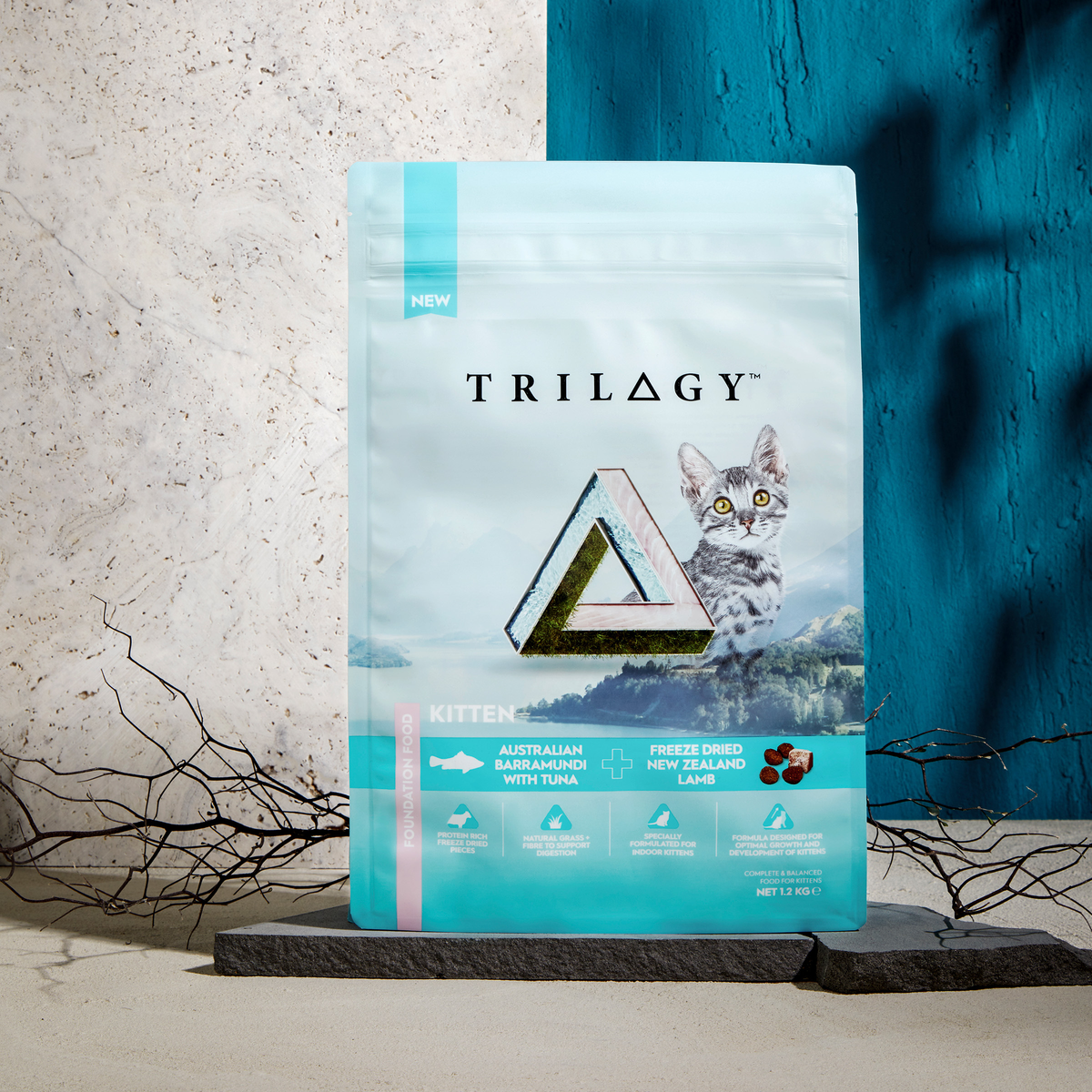 Trilogy Kitten Barramundi bag on a stand against a deep blue backdrop, lifestyle shot