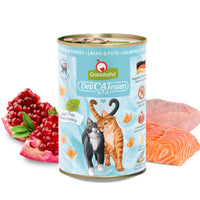 GranataPet DeliCatessen Salmon & Turkey tin in pale blue livery, beside a raw salmon fillet and turkey breast