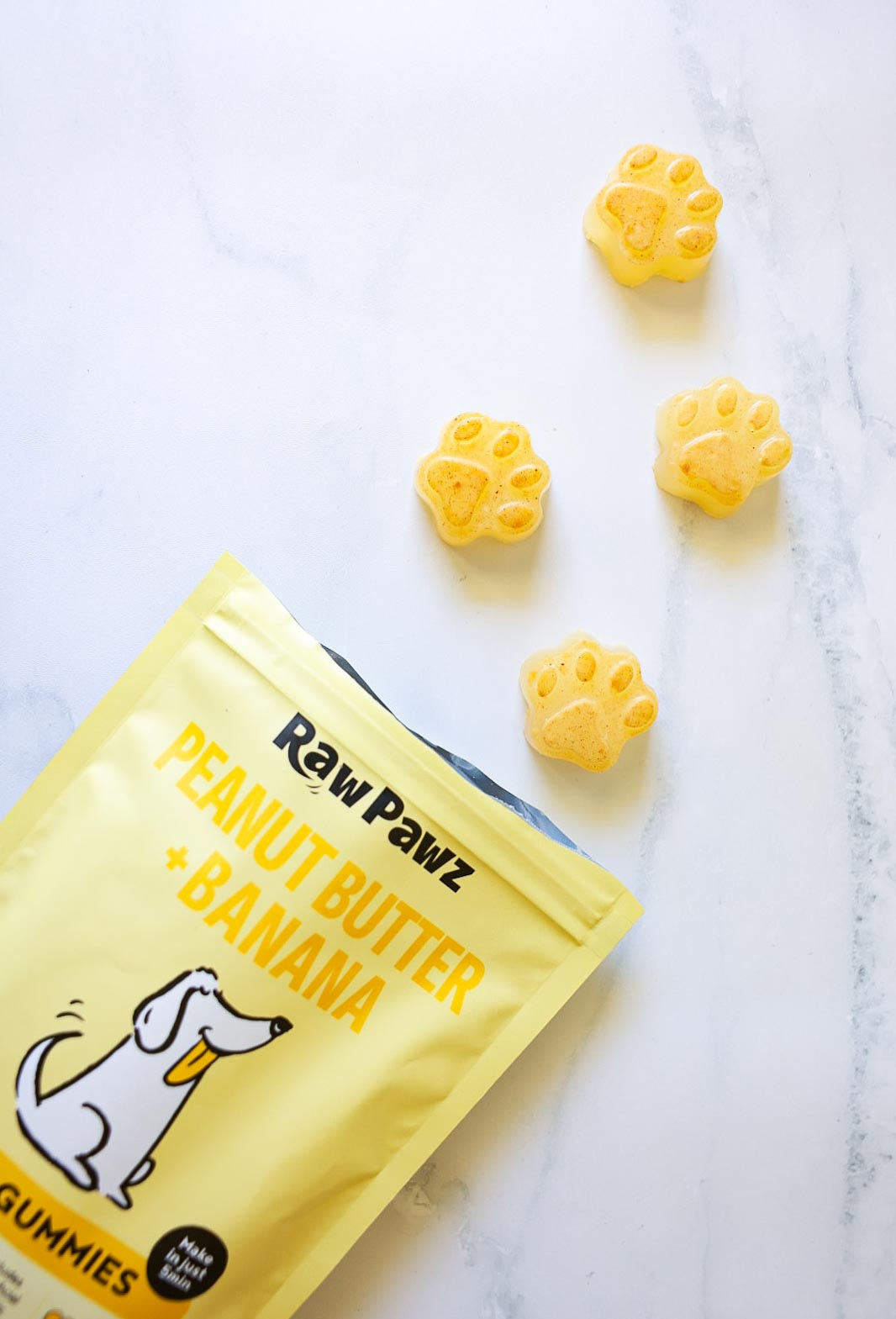 Set Raw Pawz green banana and peanut butter gummies on a plate