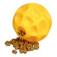 Starmark Tetraflex treat-dispensing dog ball in yellow with kibble spilling from its openings