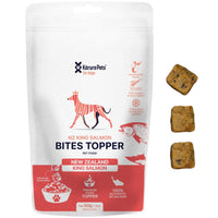 Korure Pets NZ King Salmon Bites Topper for dogs, white and red pouch with loose cube treats.