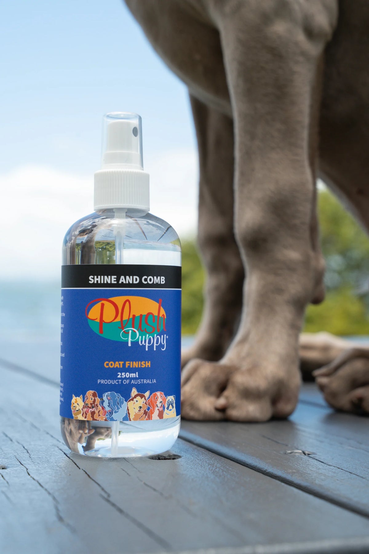 Plush Puppy Shine and Comb Shine Spray – bottle beside a dog, lifestyle photo