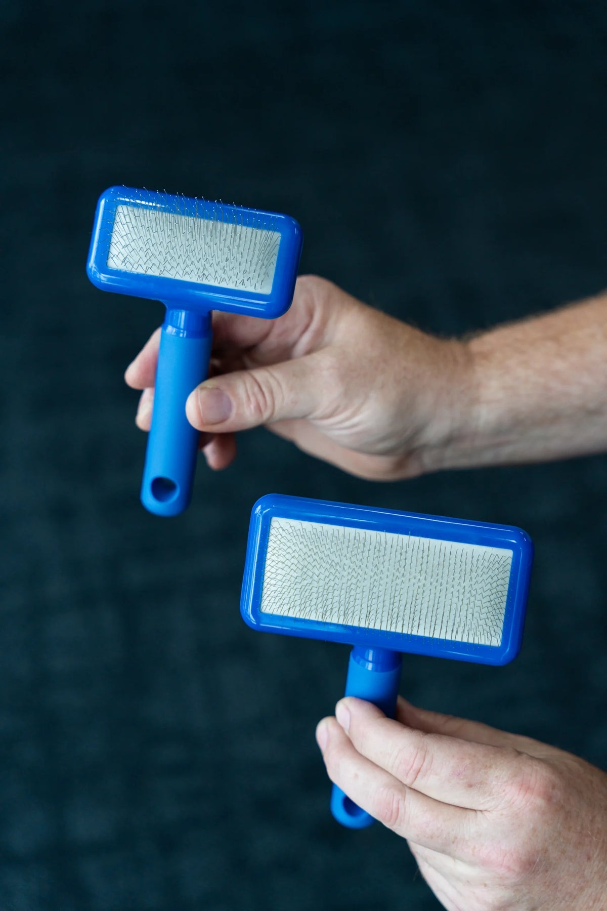 Plush Puppy Compact Long Pin Slicker Brush – held in hand to show size