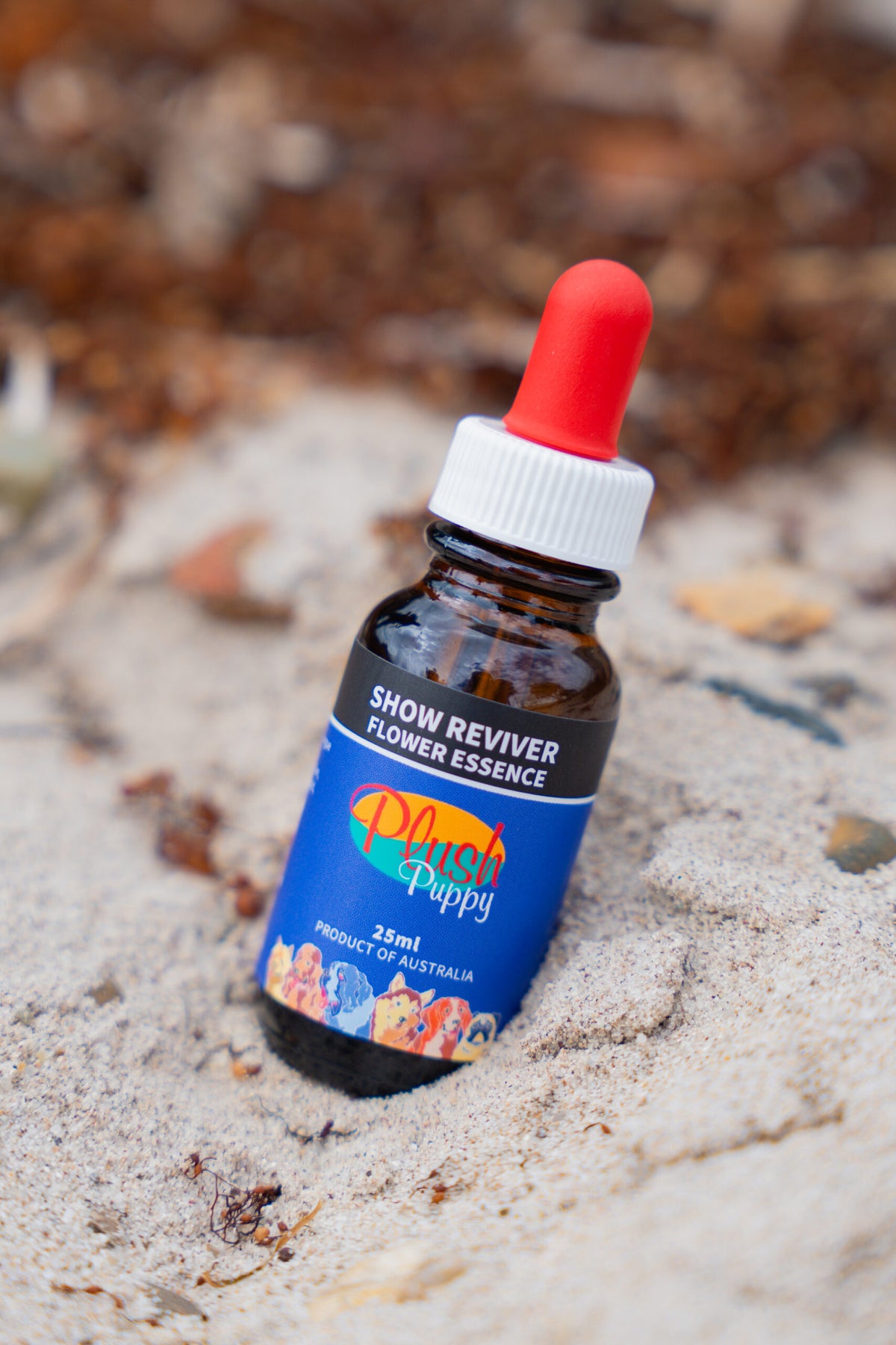 Plush Puppy Showreviver Flower Essence Drops – bottle on sand, lifestyle photo
