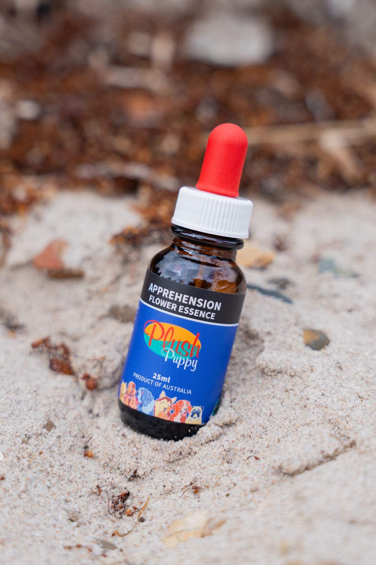 Plush Puppy Apprehension Flower Essence Drops – bottle on sand, lifestyle photo