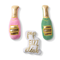 Fringe Studio Champagne mini dog toy set: pink and green plush bottles plus a Pop Fizz Clink plush.