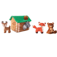 Fringe Studio On Cabin Time burrow dog toy, plush log cabin with woodland mini animals beside it.
