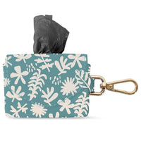 Fringe Studio Desert Flower waste bag keychain, teal floral pouch with a black bag pulled through.