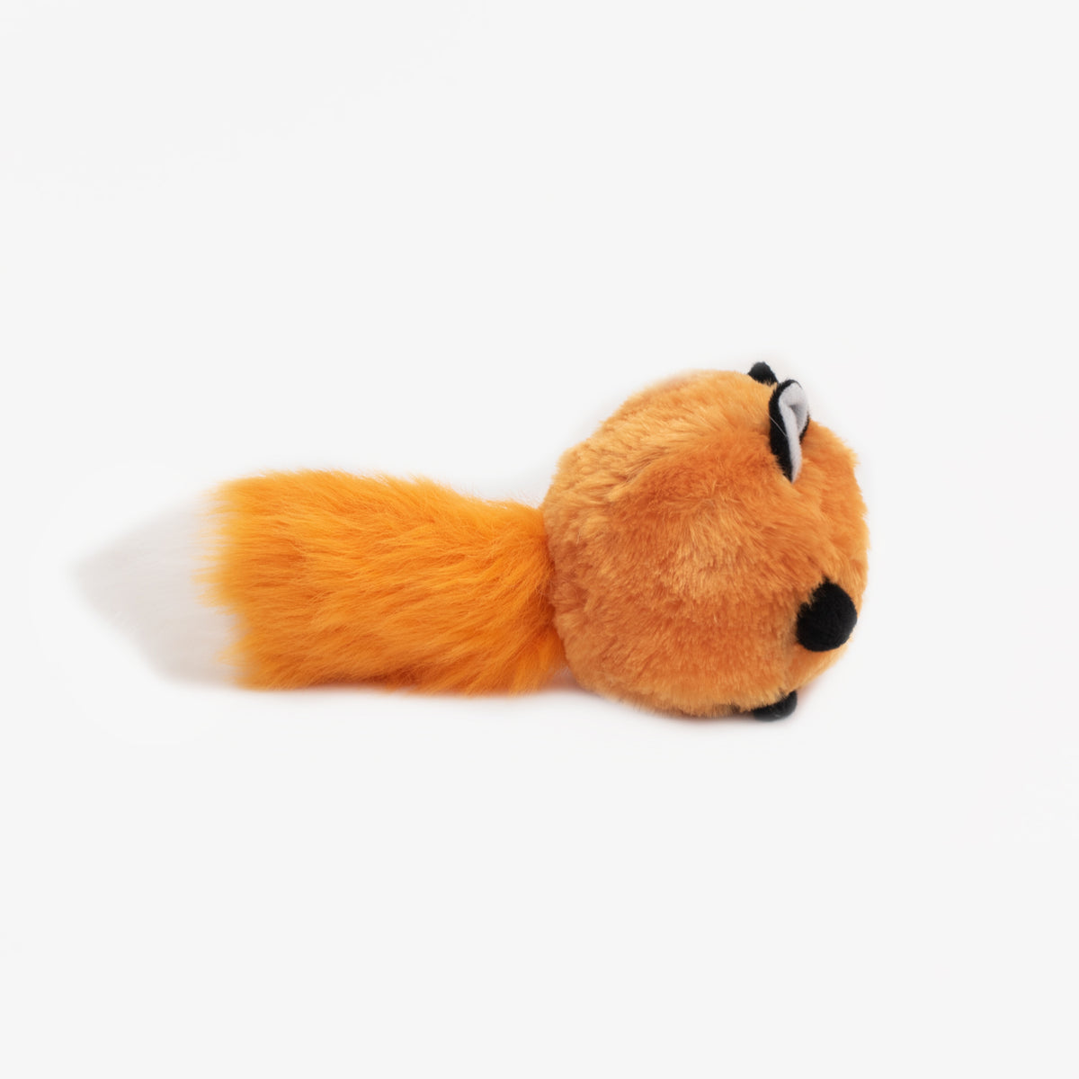Dog carrying the Zippy Paws Bushy Throw Fox by the tail