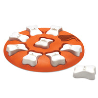 Nina Ottosson Dog Smart Level 1 puzzle, orange disc with white bone-shaped treat covers