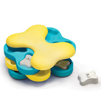 Nina Ottosson Dog Tornado Level 2 puzzle, yellow and teal rotating layers with a white bone peg