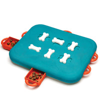 Nina Ottosson Dog Casino Level 3 puzzle, teal board with white bone pegs and orange sliding drawers
