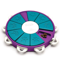 Nina Ottosson Dog Twister Level 3 puzzle, purple board with teal rotating segments and bone pegs
