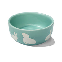 Nature Island mint green ceramic pet bowl with white rabbit silhouettes around the outside
