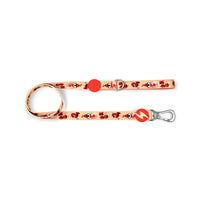 Dashi Tribes dog lead in cream with a red cartoon tribal print, bolt tag and silver trigger clip