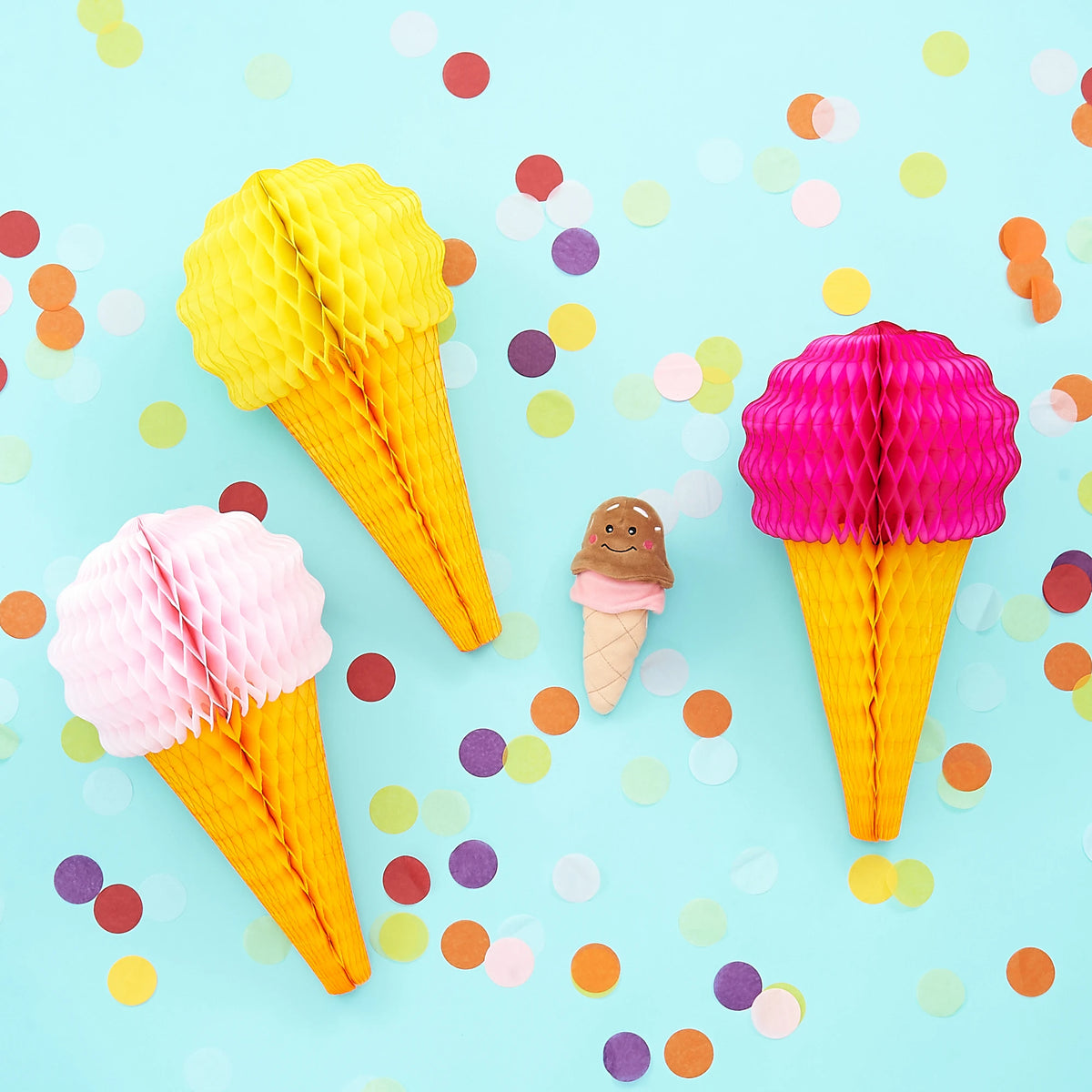Zippy Paws NomNomz ice cream plush dog toy styled among paper decorations and confetti