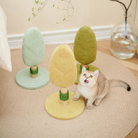 A cat beside the Petsbelle Lollipop cat trees, tree-shaped sisal posts in mint, yellow and olive