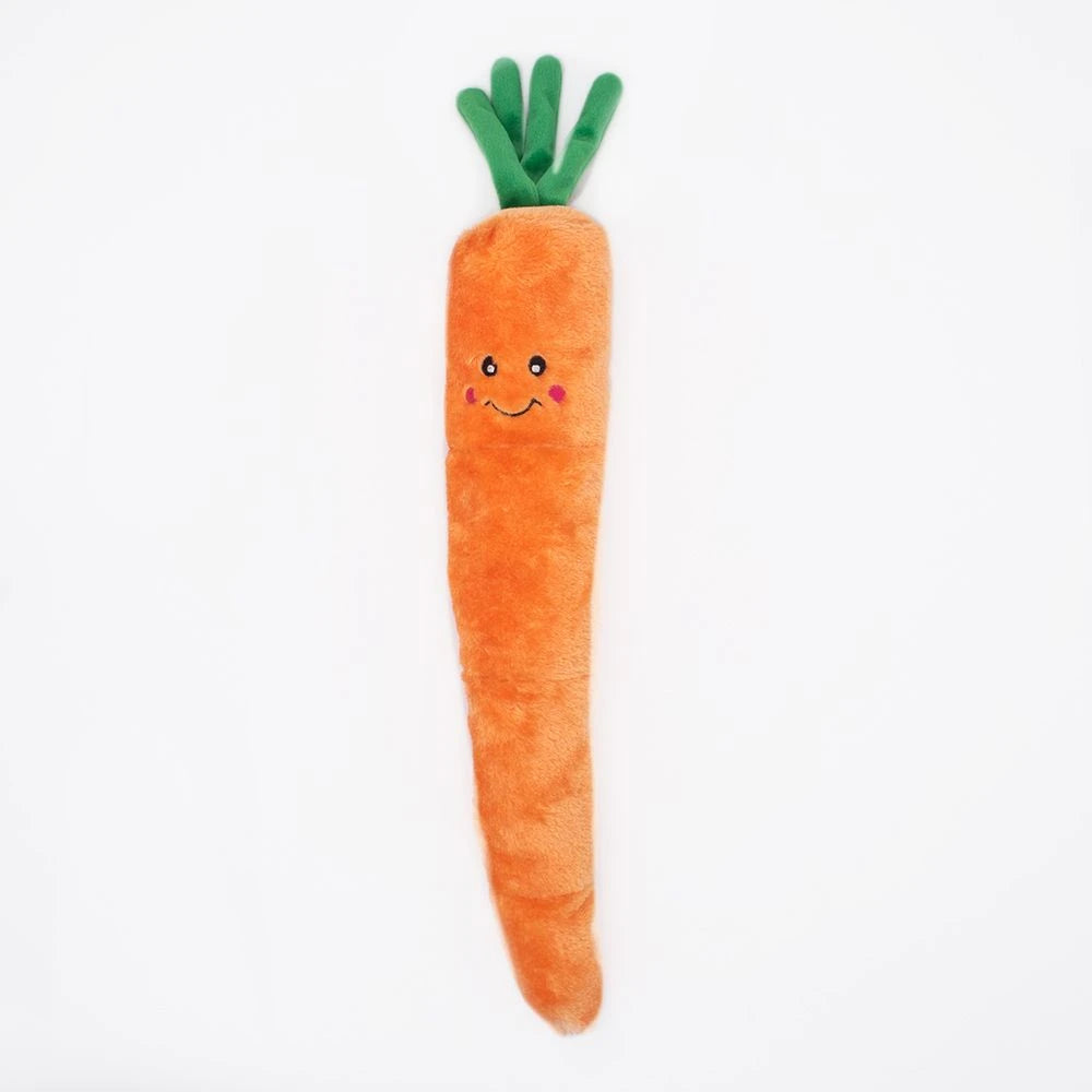 Zippy Paws Jigglerz plush carrot dog toy with a smiling face and green top, on white