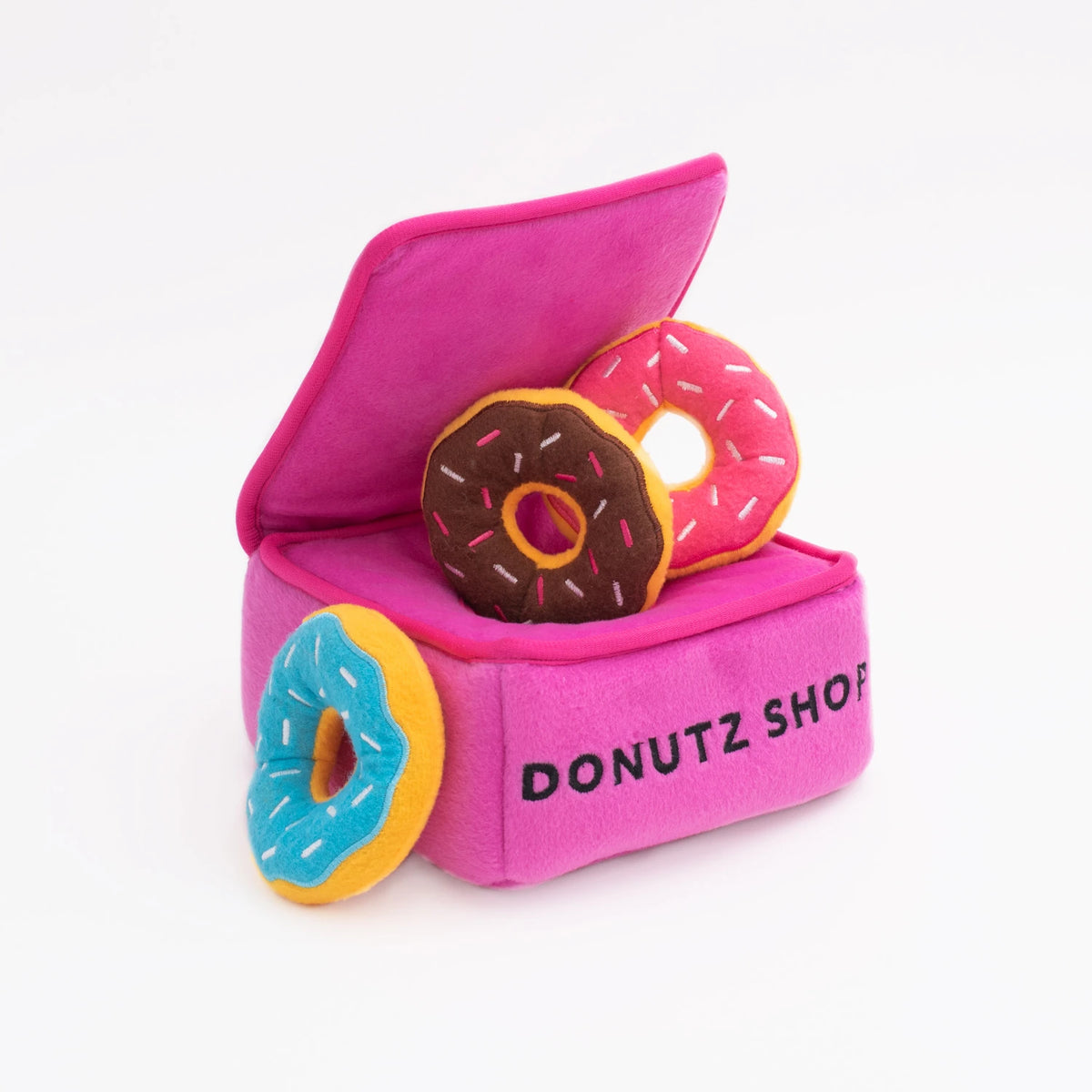 Zippy Paws Donutz Burrow pink box dog toy with brown and blue plush donuts