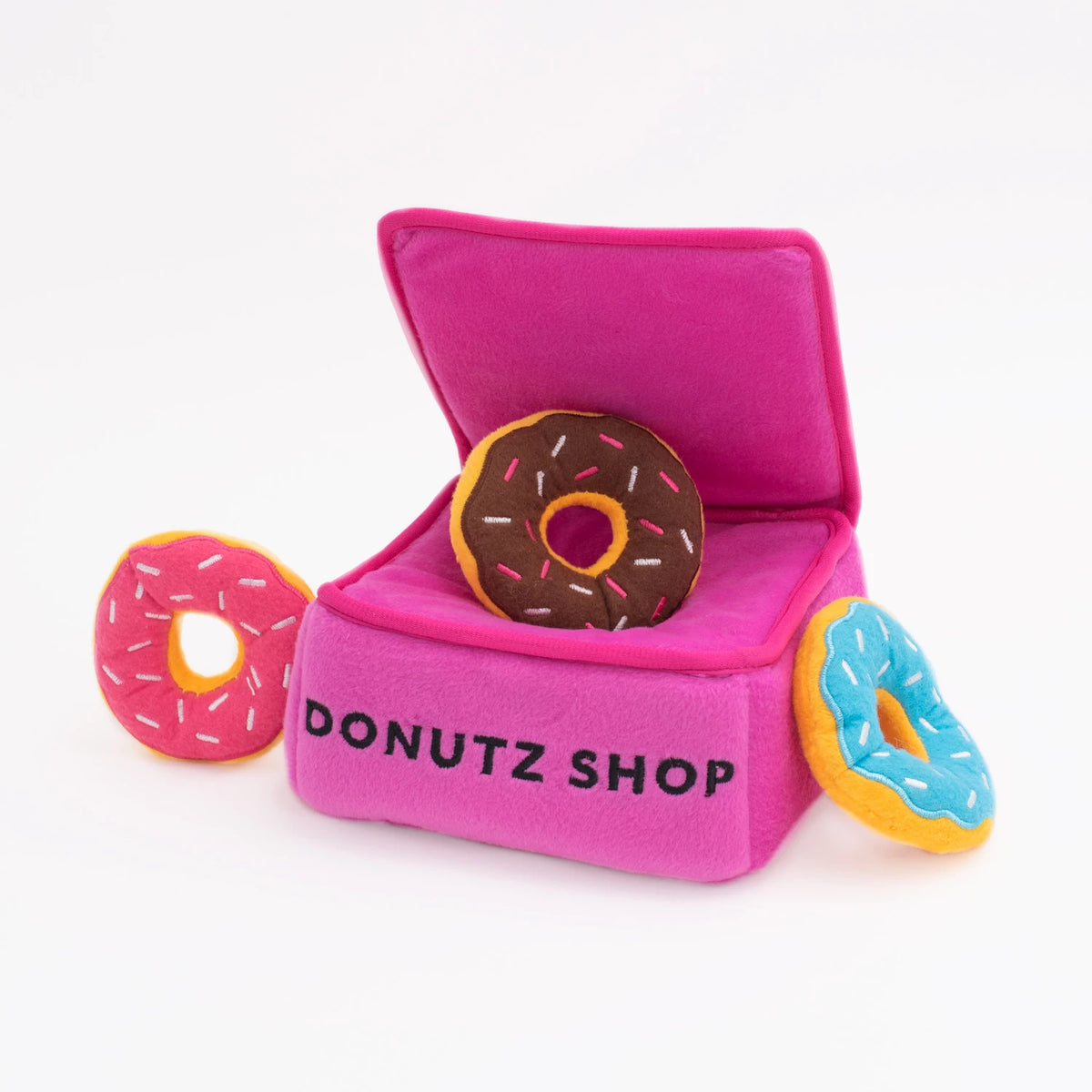 Zippy Paws Donutz Burrow plush dog toy: a pink Donutz Shop box with squeaky donuts