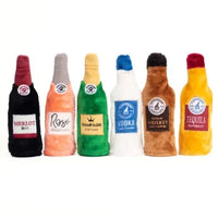 Six Zippy Paws Happy Hour Crusherz plush bottle dog toys lined up side by side