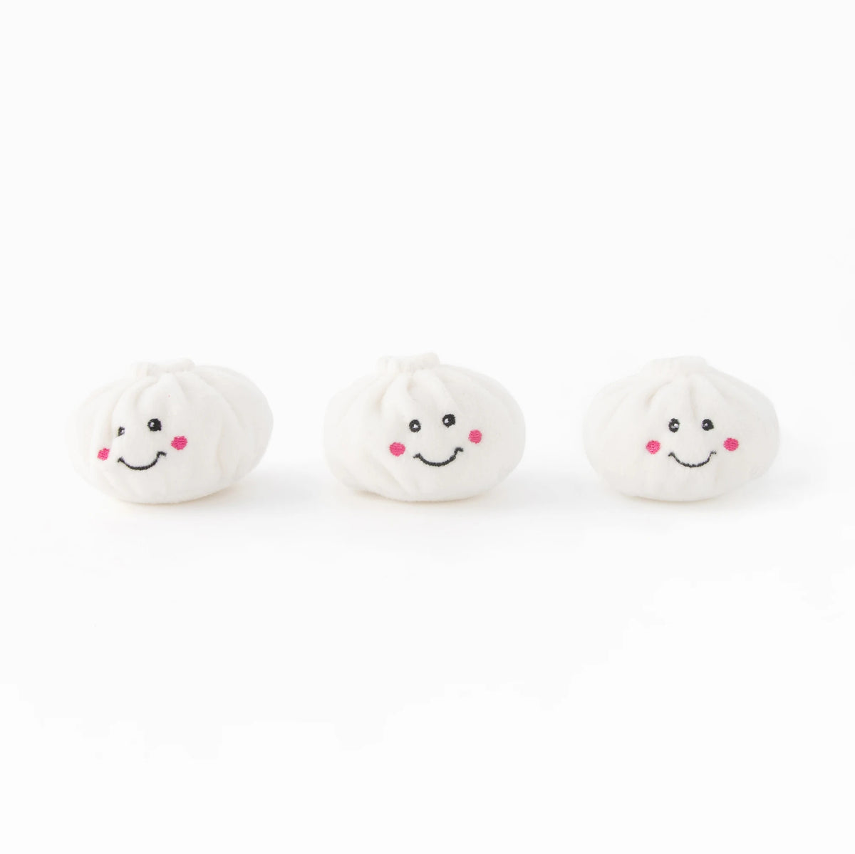 The three plush dumpling squeakers from the Zippy Paws Burrow soup dumplings dog toy