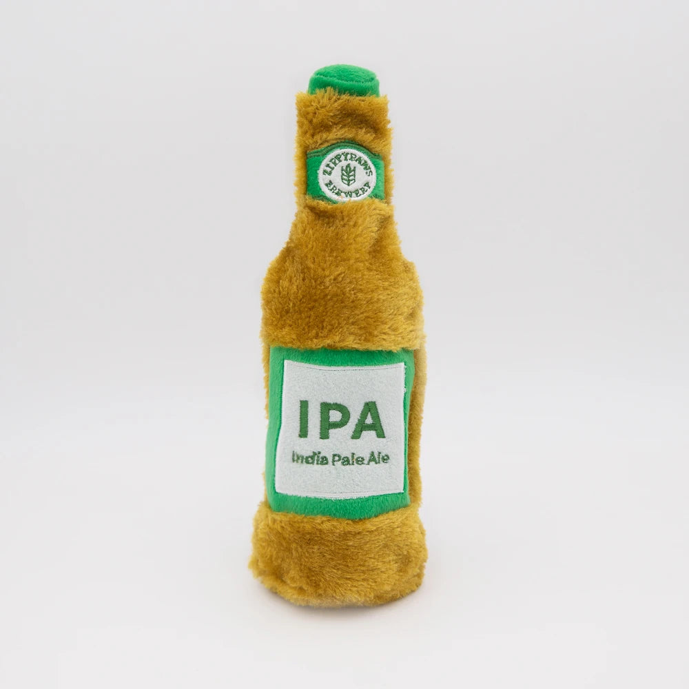 Zippy Paws Happy Hour Crusherz plush dog toy shaped as an IPA beer bottle, on white