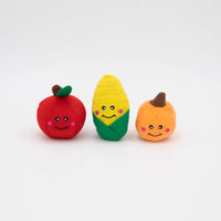 Three small Zippy Paws Miniz plush dog toys: an apple, a corn cob and a pumpkin