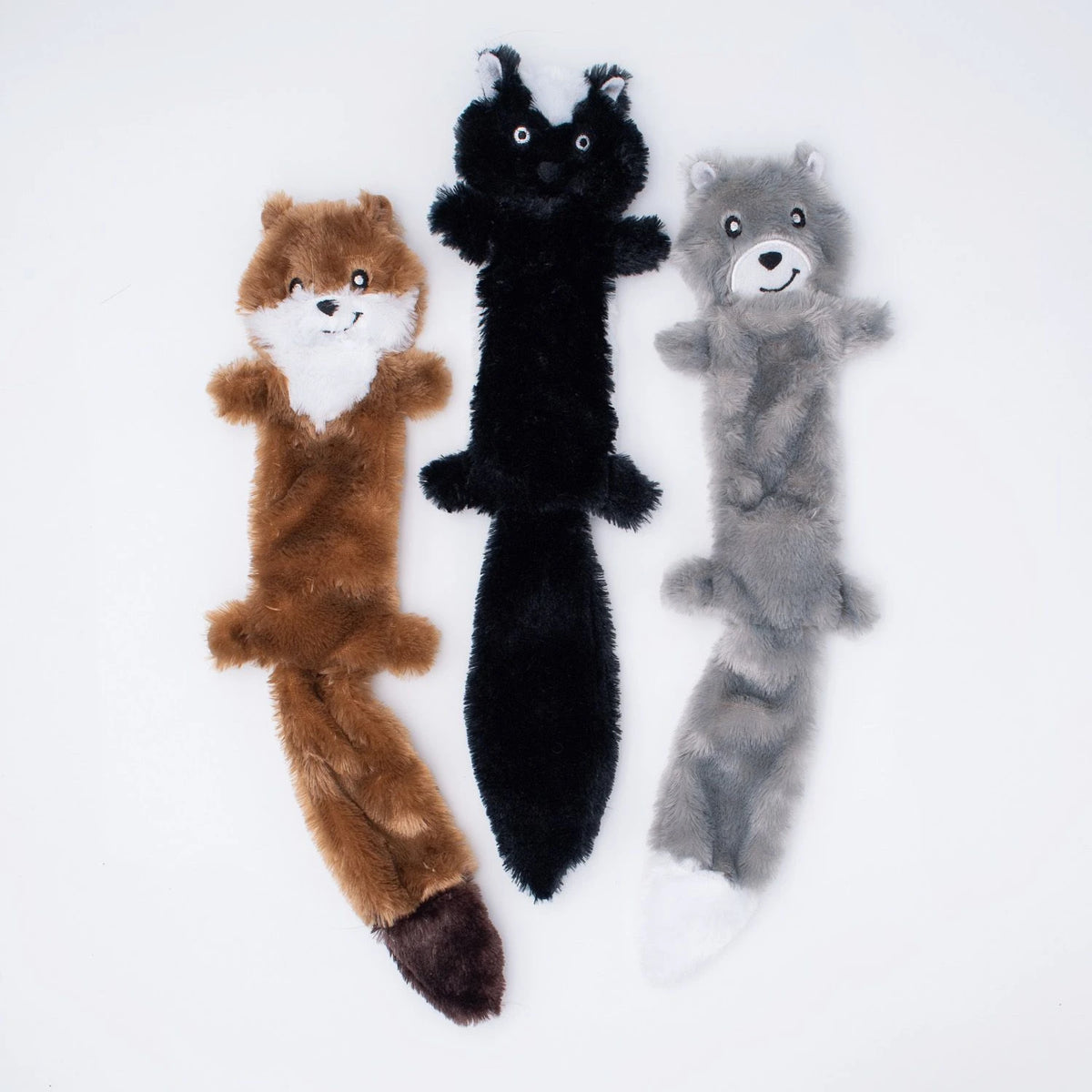 Three Zippy Paws Skinny Peltz stuffing-free plush dog toys: weasel, skunk and wolf