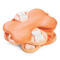 Nina Ottosson Puppy Tornado puzzle, peach bone-shaped rotating layers with white bone pegs