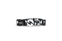 Dashi Astronaut dog collar in black with a white space print, lightning-bolt tag and D-ring, done up on white